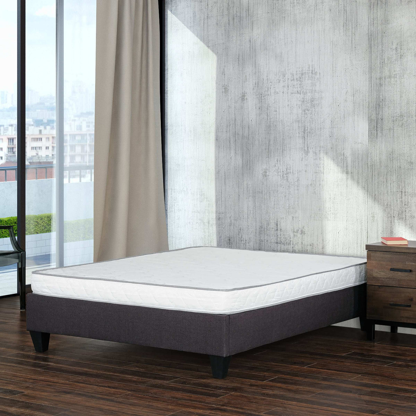 Modern bedroom with minimalist mattress on dark bed frame, hardwood floor, and city view
