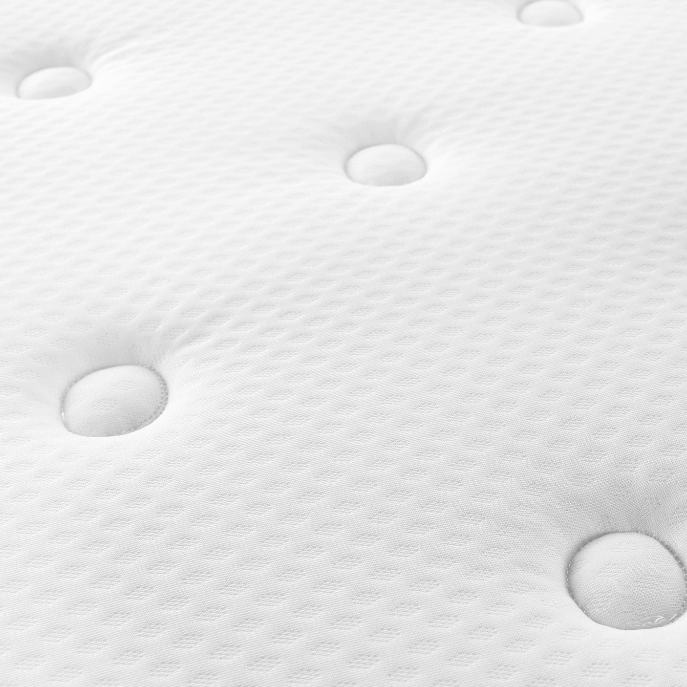 Close-up of white textured mattress with tufted button design