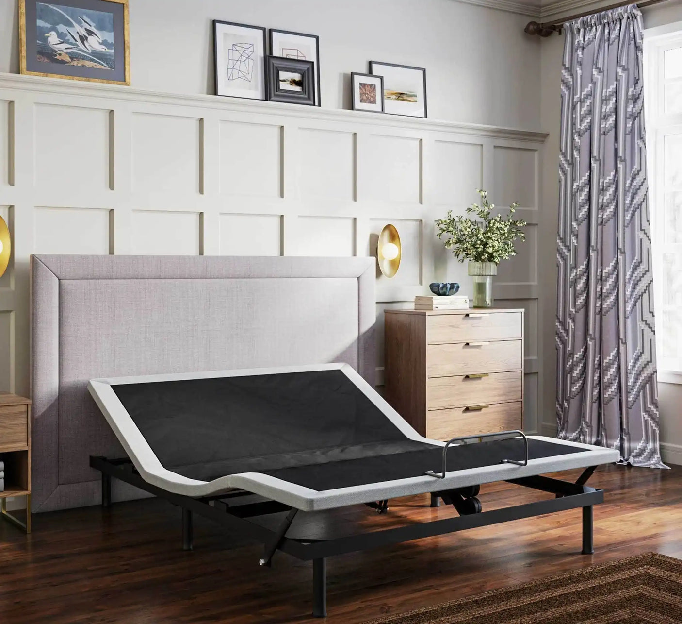 Adjustable bed frame in modern bedroom with large headboard, wood floor, and stylish decor