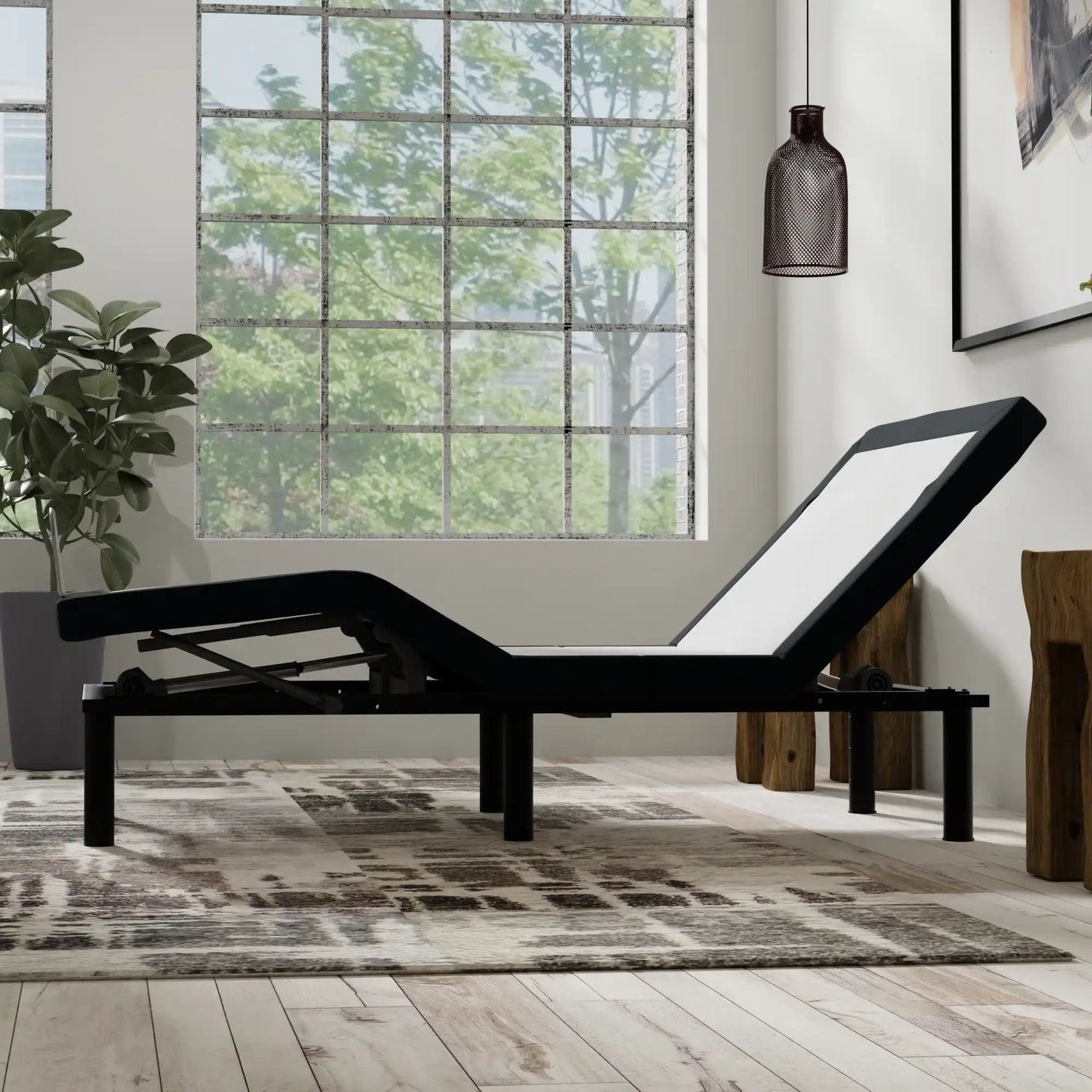 Adjustable bed frame in modern bedroom with large window and indoor plant