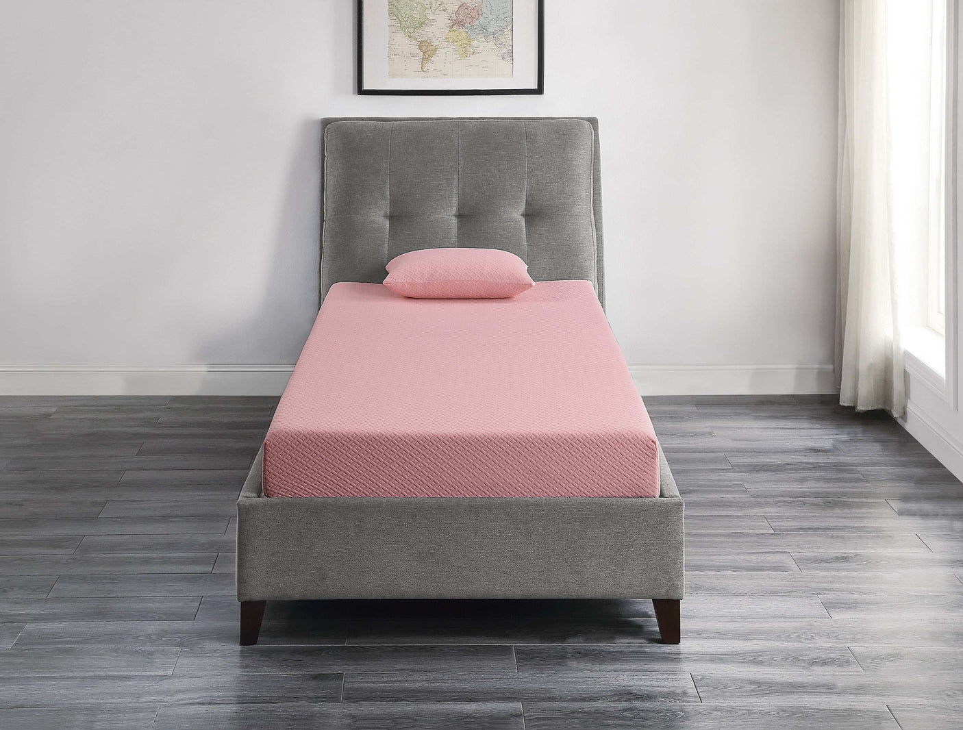Pink twin mattress with pillow on grey upholstered bed in modern bedroom