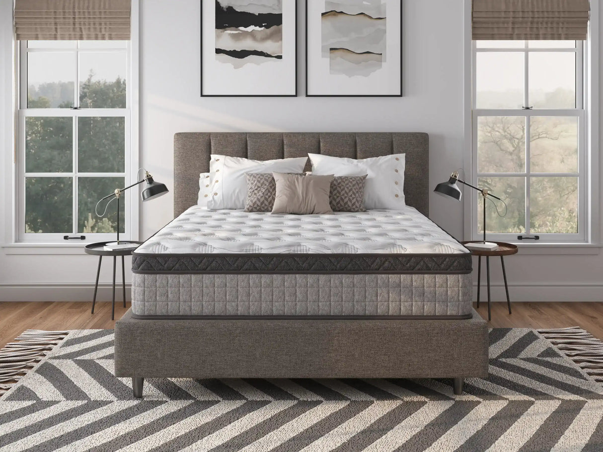 Modern bedroom with a gray upholstered bed, luxury mattress, and stylish decor
