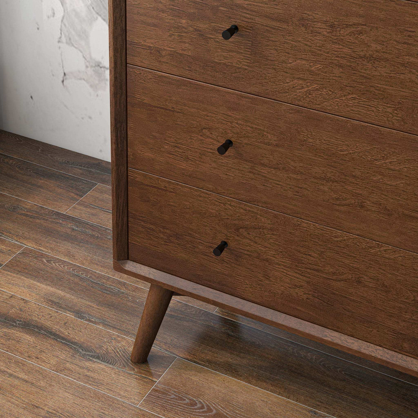Mid-century modern wooden dresser with black drawer pulls on wood floor