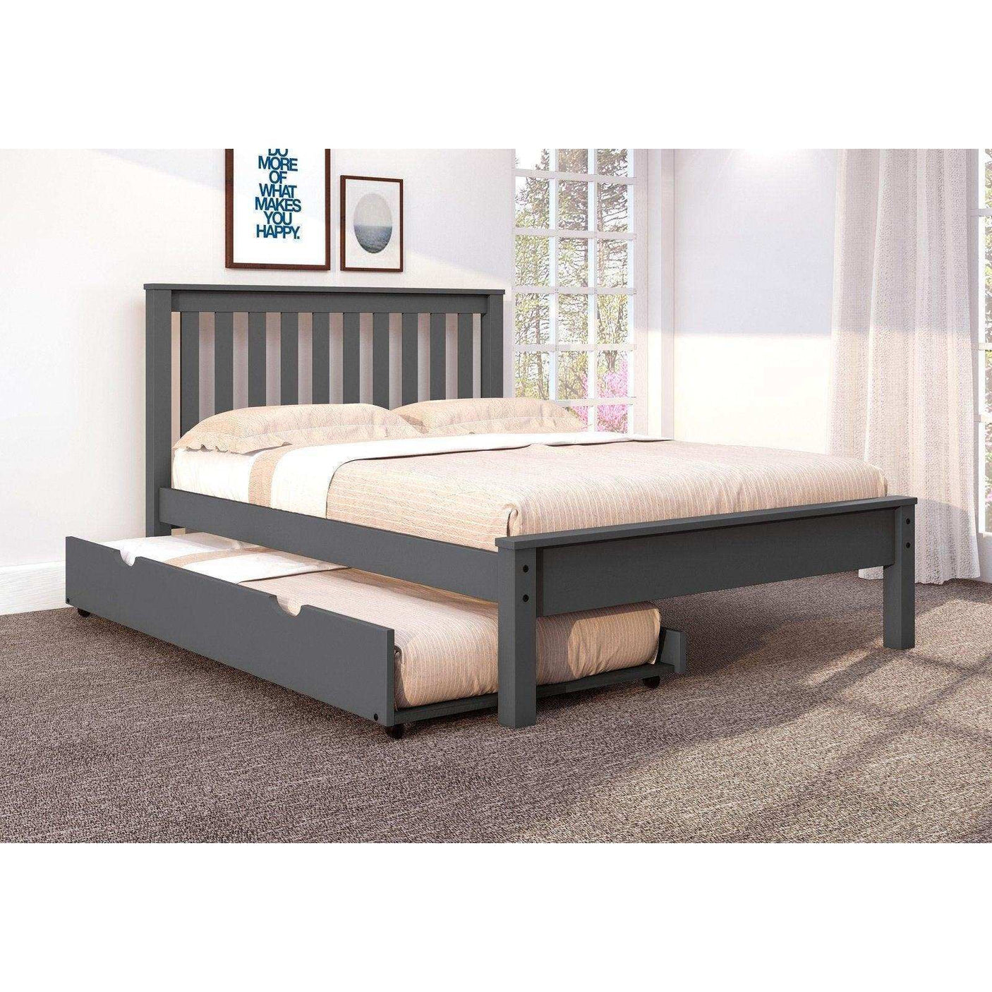 Gray wooden full bed with trundle in bright carpeted bedroom, large windows, wall art