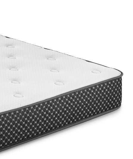 Close-up of a white quilted mattress with black patterned sides on a white background