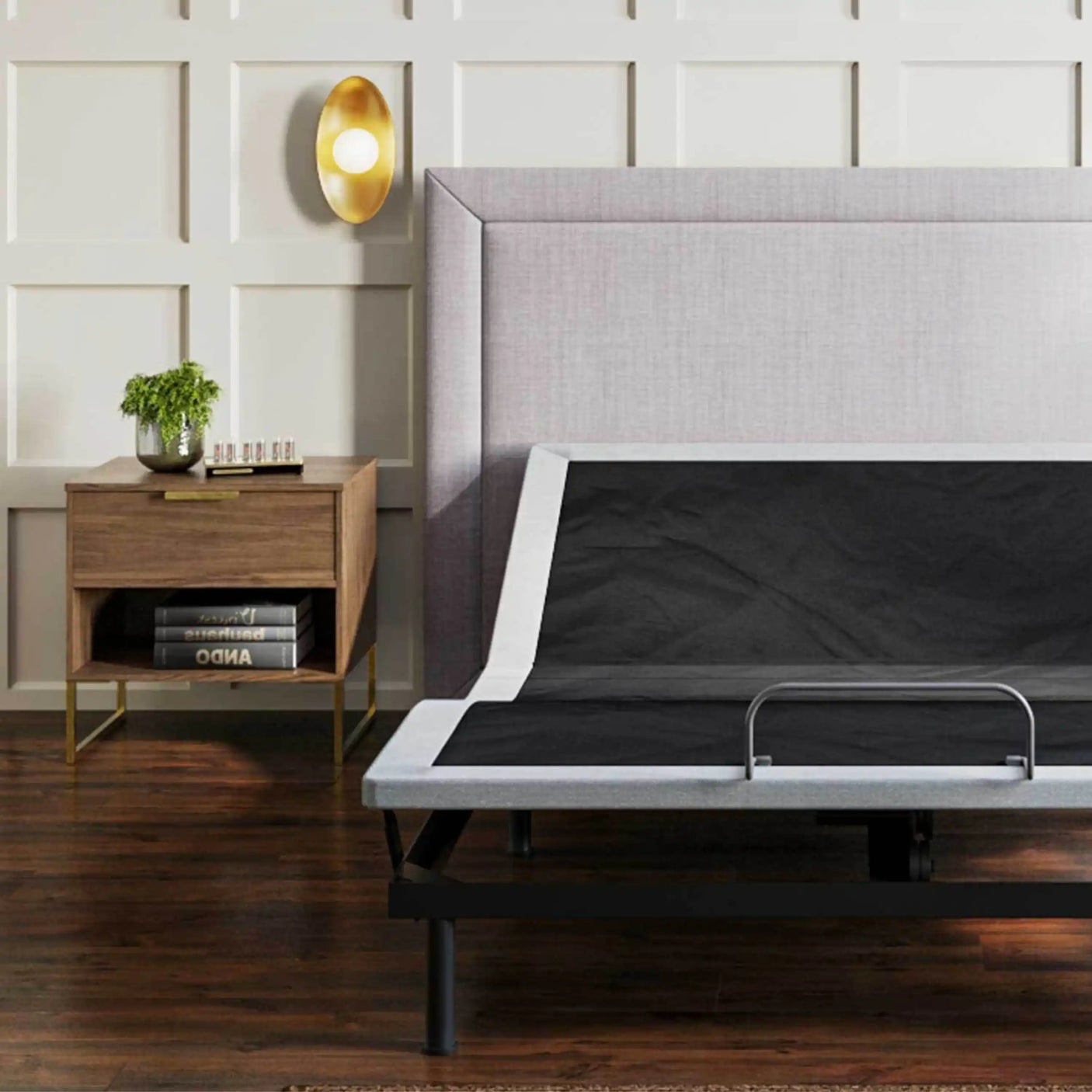 Modern bedroom with adjustable bed frame, gray headboard, wood nightstand, and wall lamp