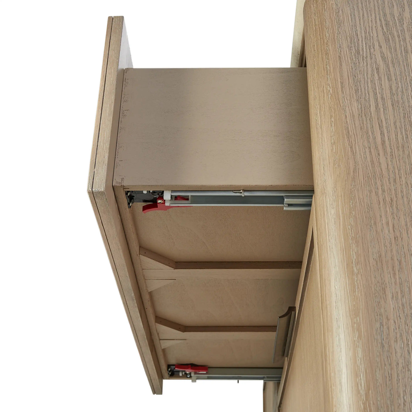 Wooden drawer on metal slides with red release clips, close-up underside view