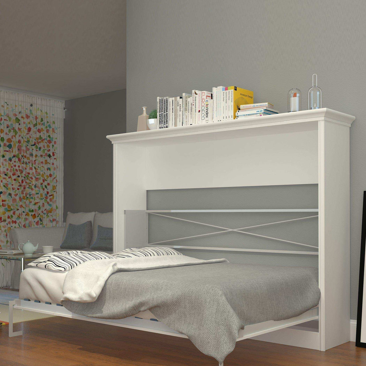 White horizontal Murphy bed with books on top in a modern bedroom setting