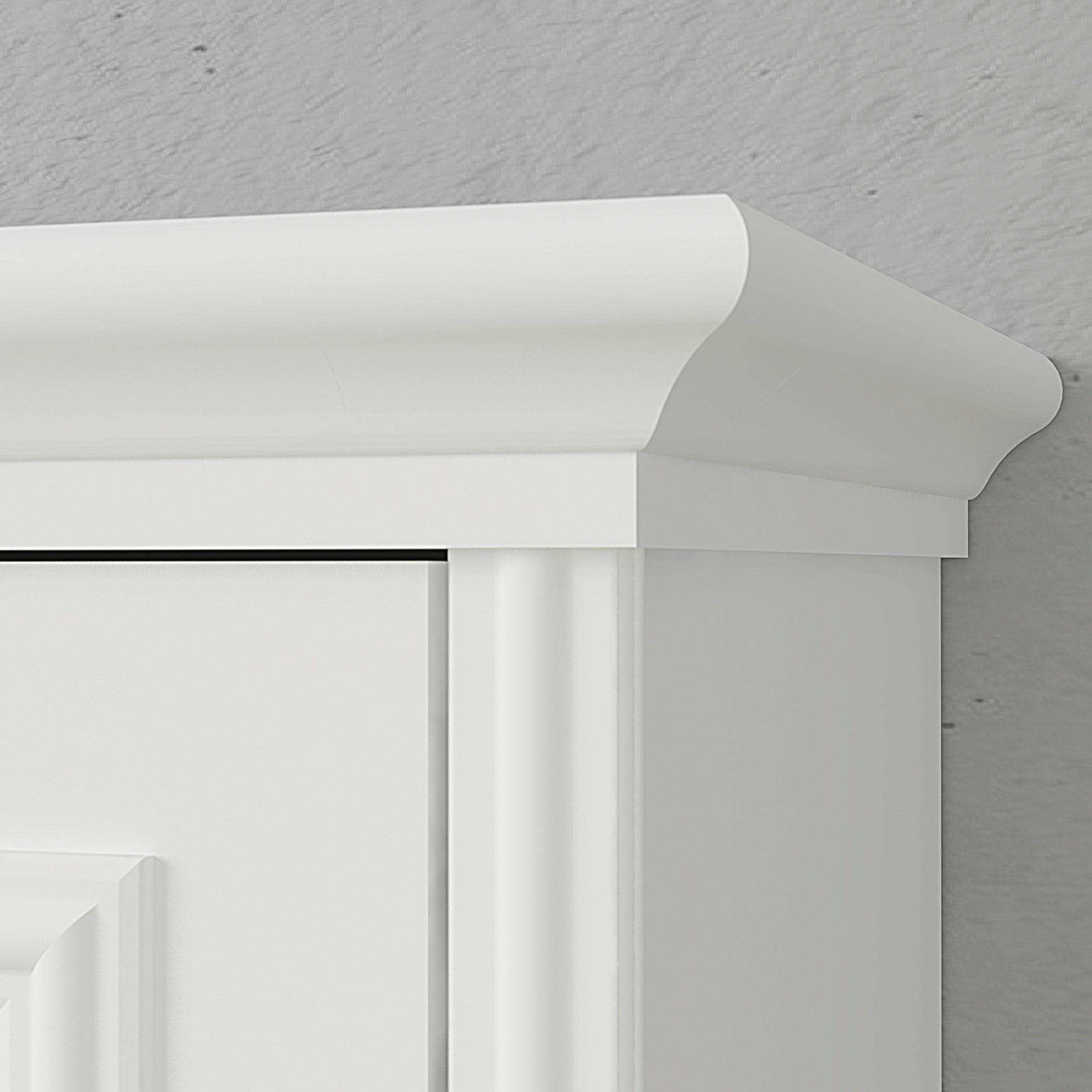 White wood Murphy bed cabinet with crown molding detail against a gray wall