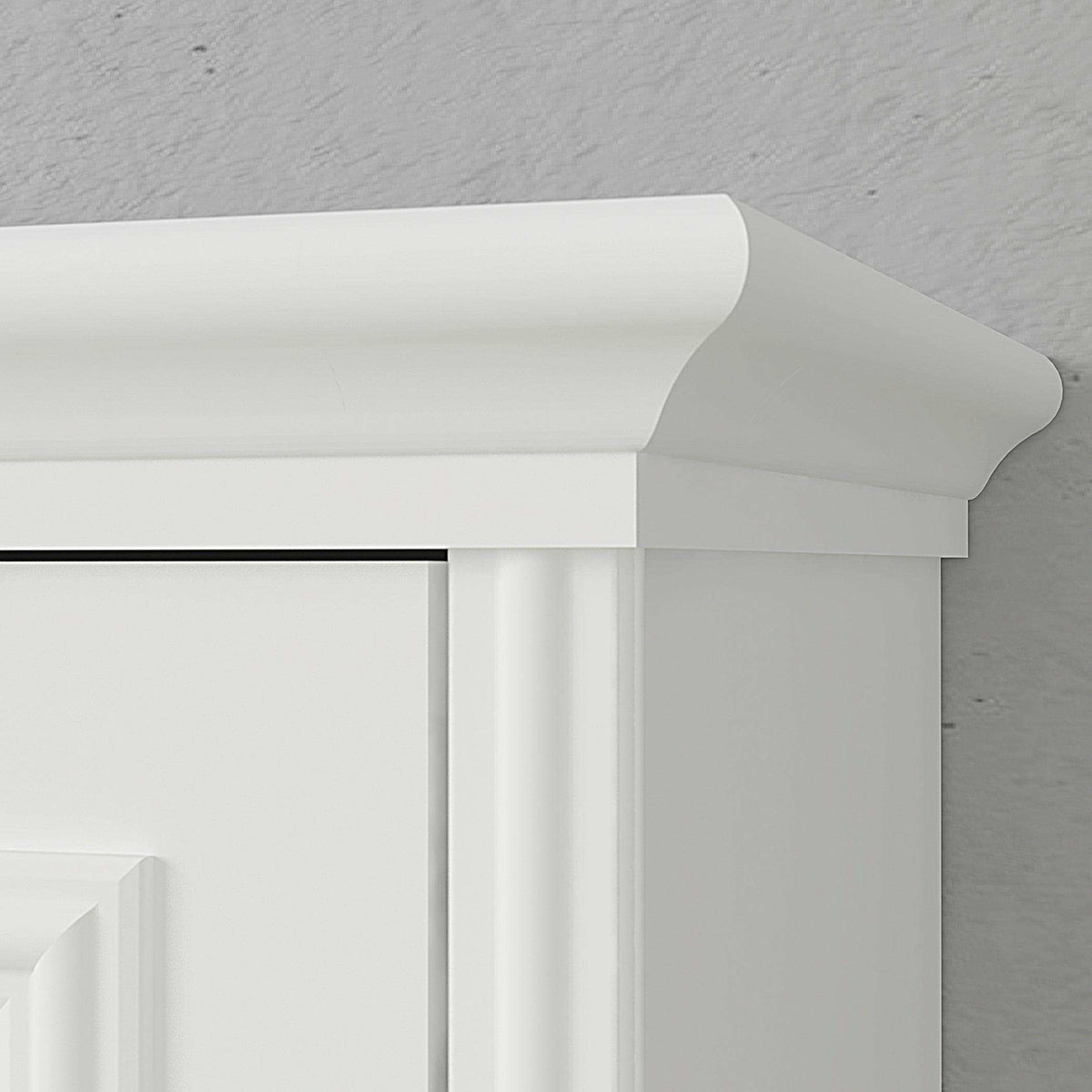 White wood Murphy bed cabinet with crown molding detail against a gray wall