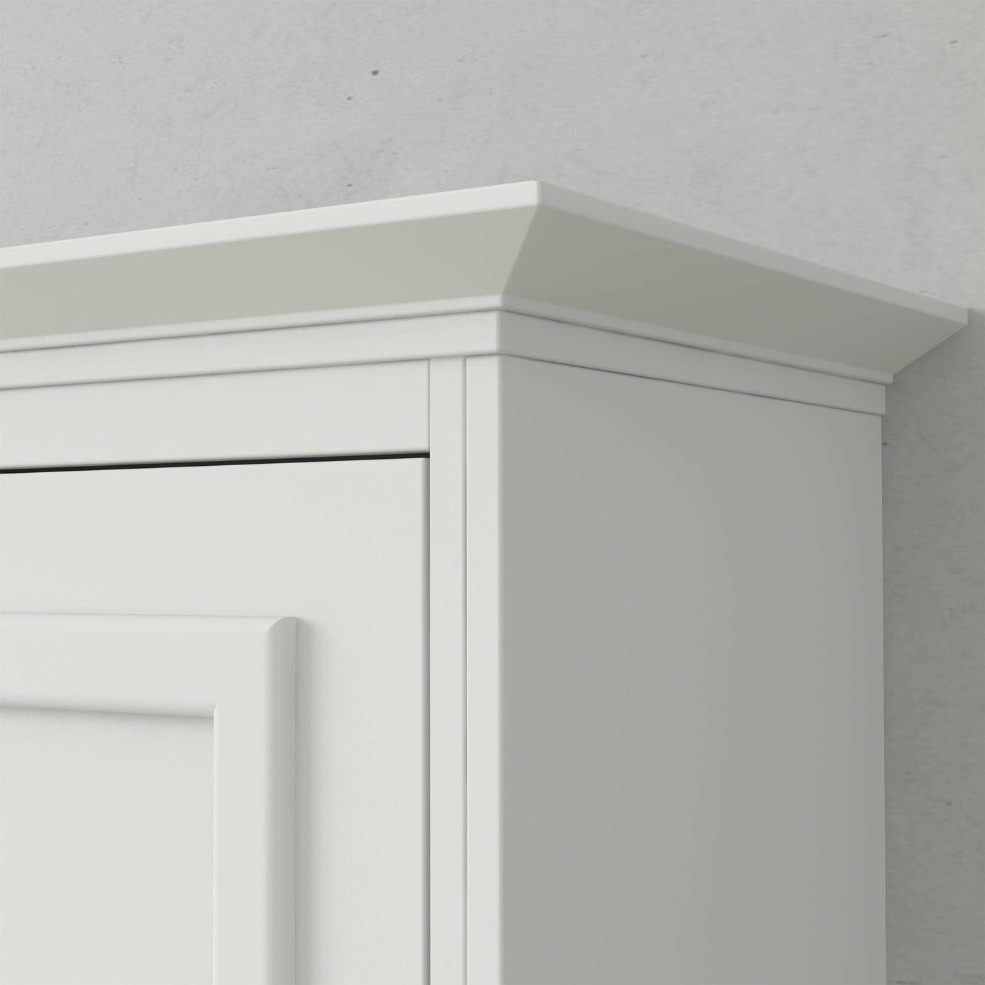 White vertical Murphy bed cabinet with crown molding detail against gray wall