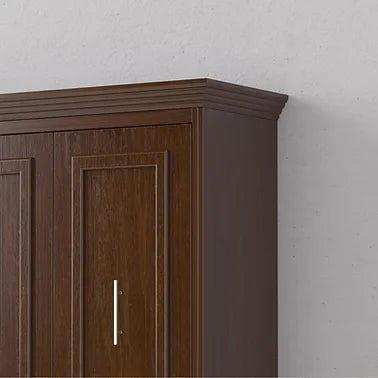 Vertical walnut Murphy bed cabinet with crown molding against a light wall