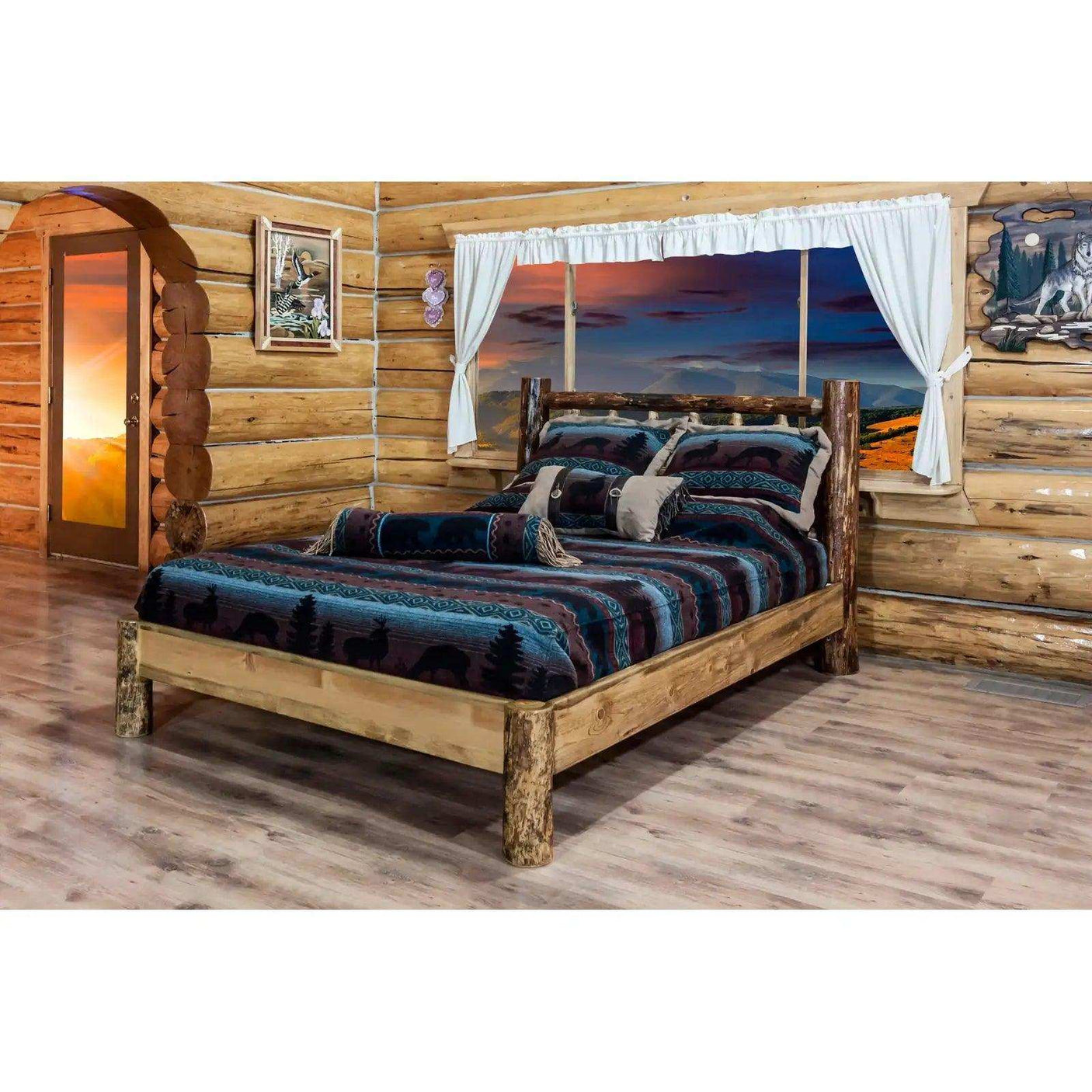 Rustic log platform bed with wildlife bedding in a cozy log cabin bedroom