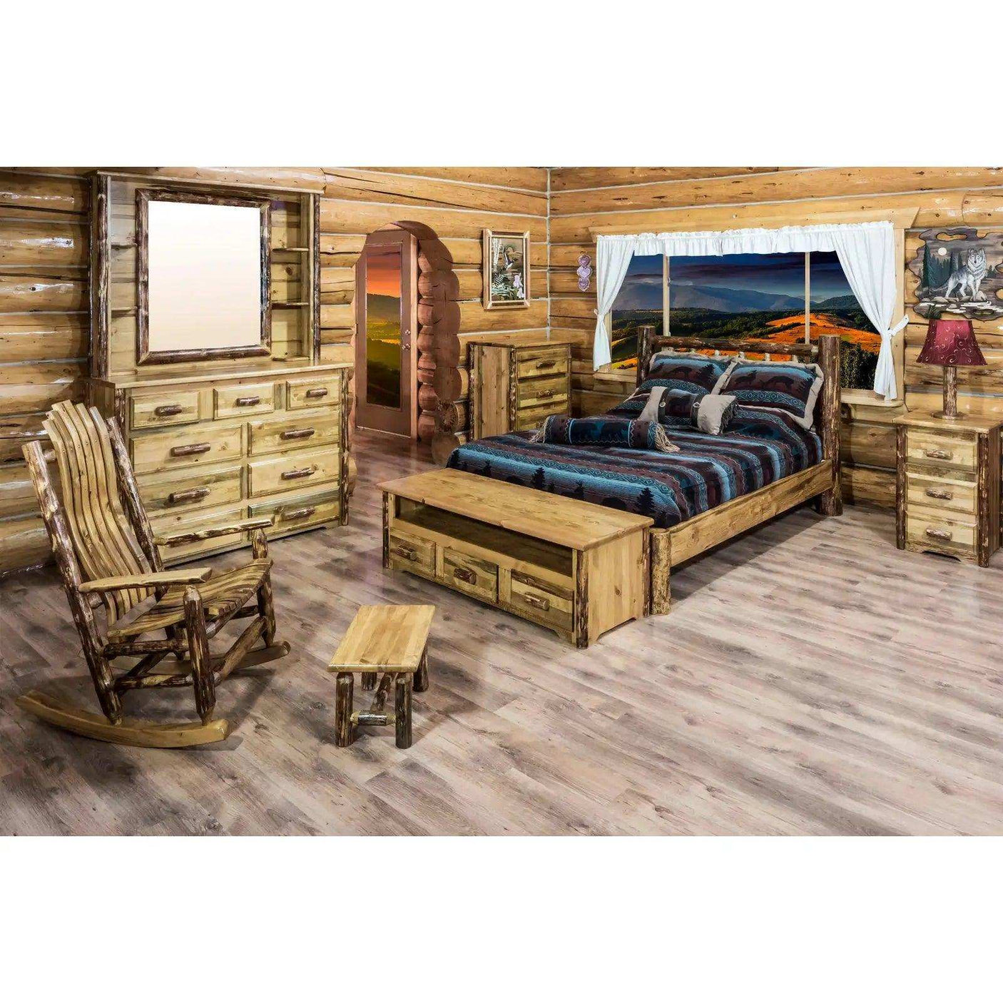 Rustic log cabin bedroom with full platform bed, wood furniture, and scenic window view