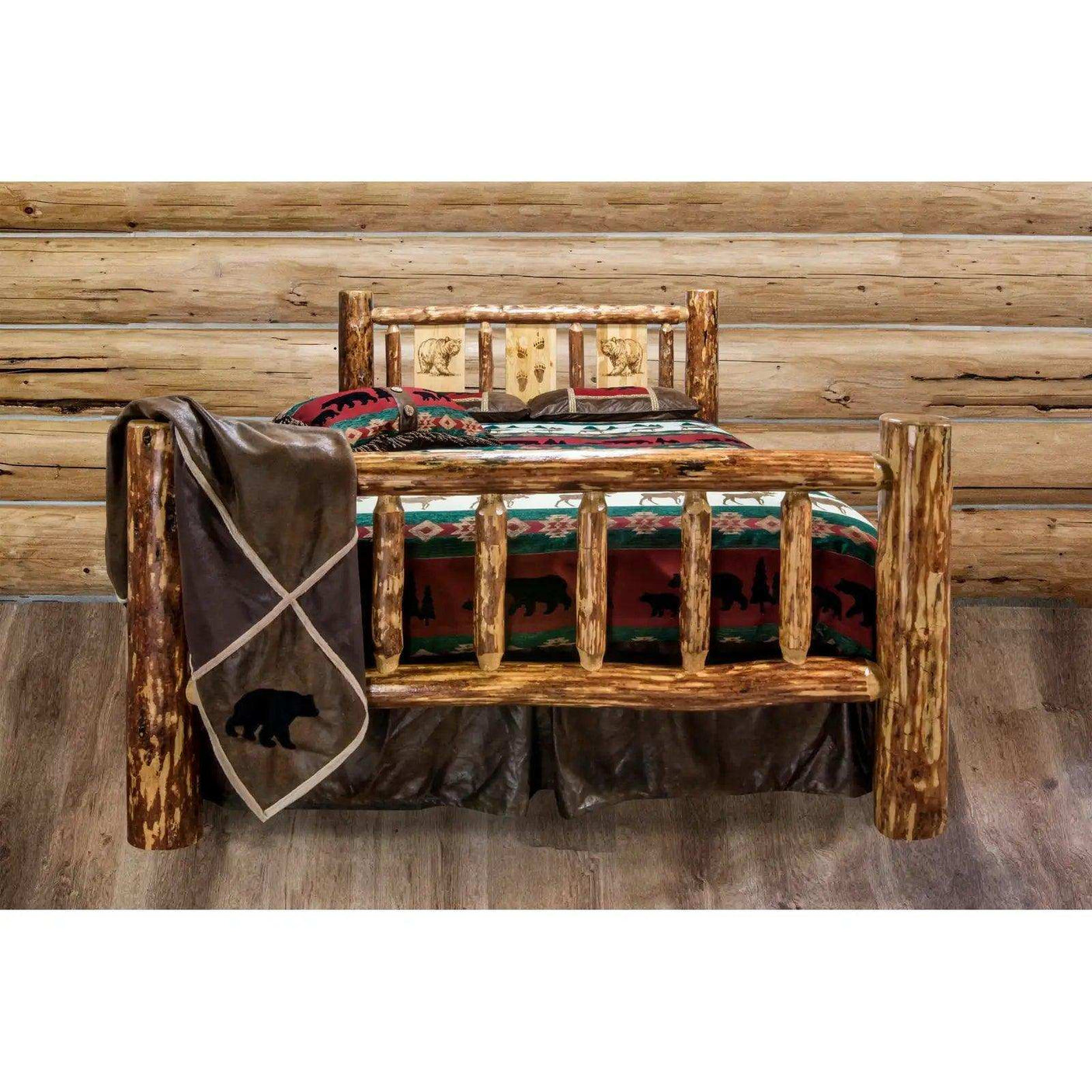 Rustic king bed with laser-engraved log frame and wildlife bedding in cabin bedroom