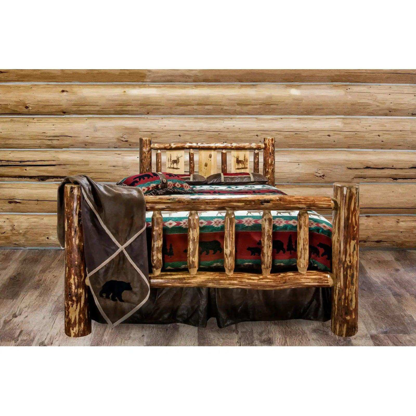 Rustic log queen bed with laser engraved wildlife design in a wooden cabin bedroom setting.
