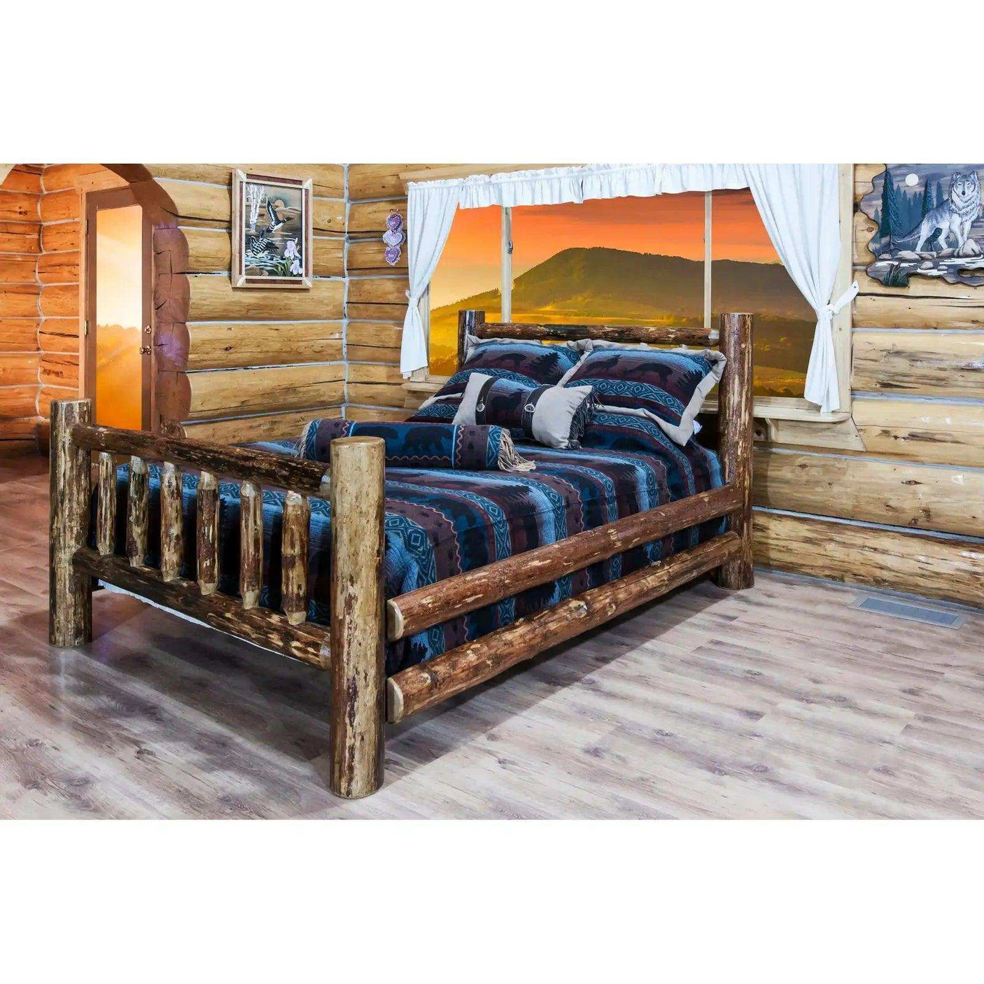 Rustic log twin bed with patterned bedding in a cozy log cabin bedroom at sunset.