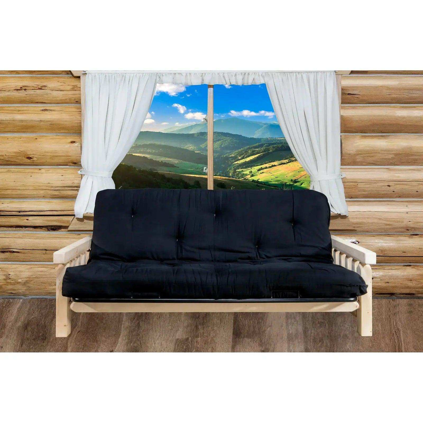 Homestead futon frame with black mattress in log cabin room, mountain view window