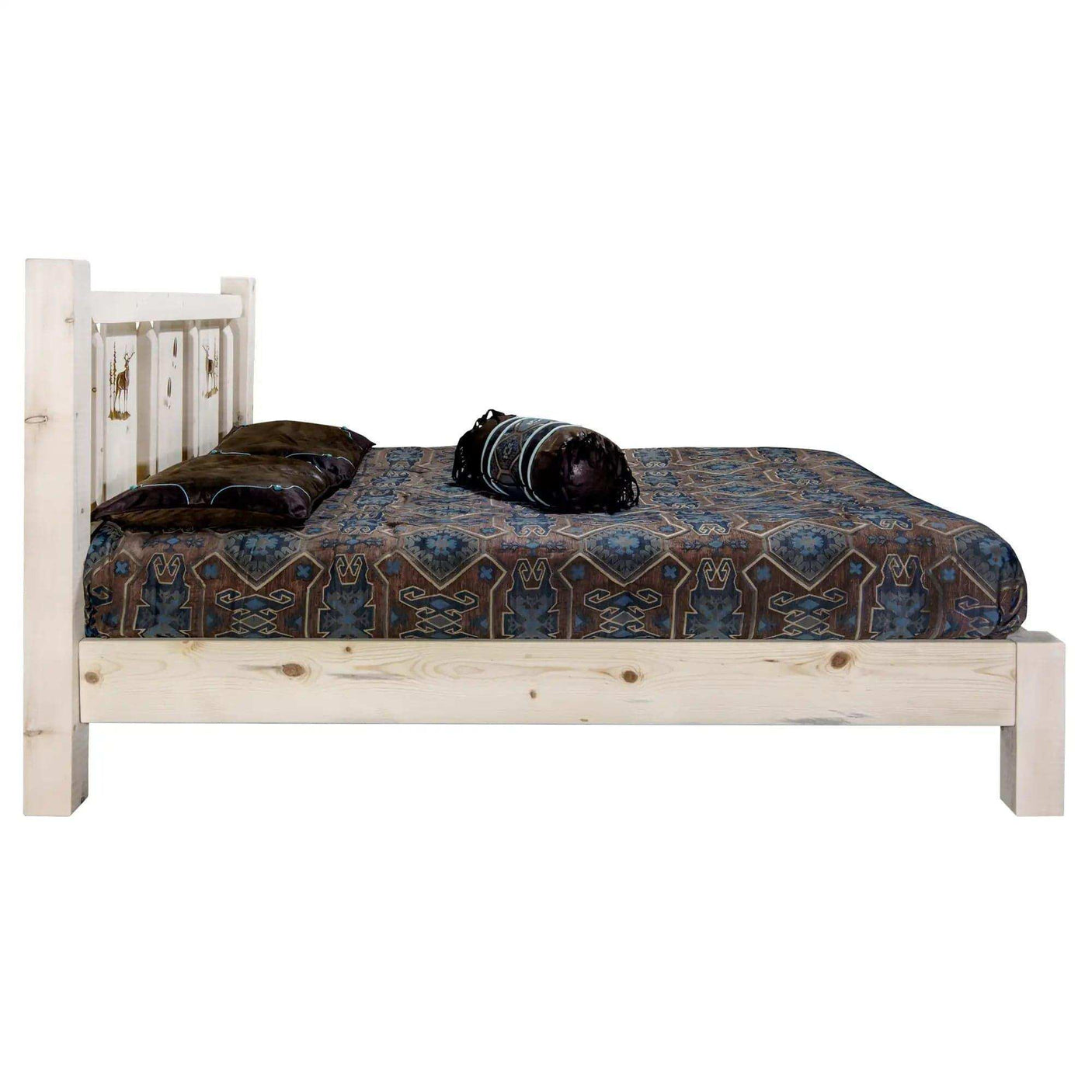 King platform bed with laser-engraved headboard and clear lacquer finish, rustic bedding