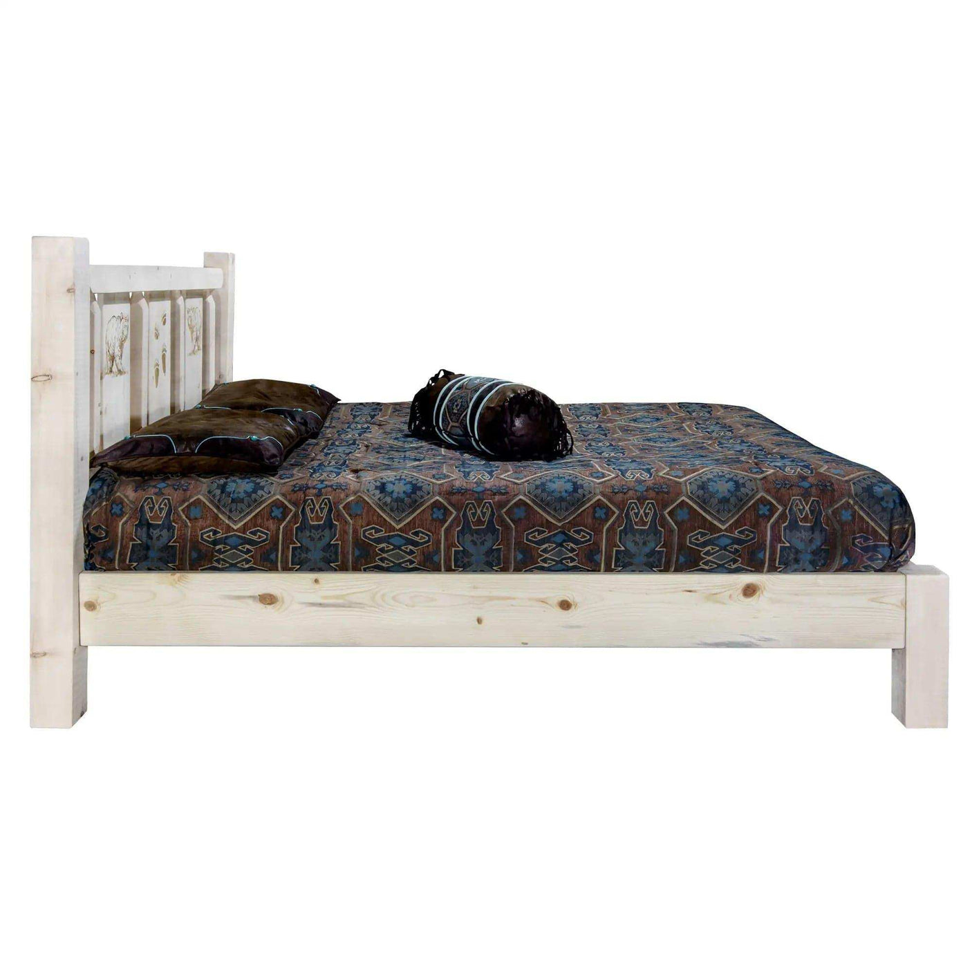Rustic queen platform bed with laser-engraved headboard and patterned bedding