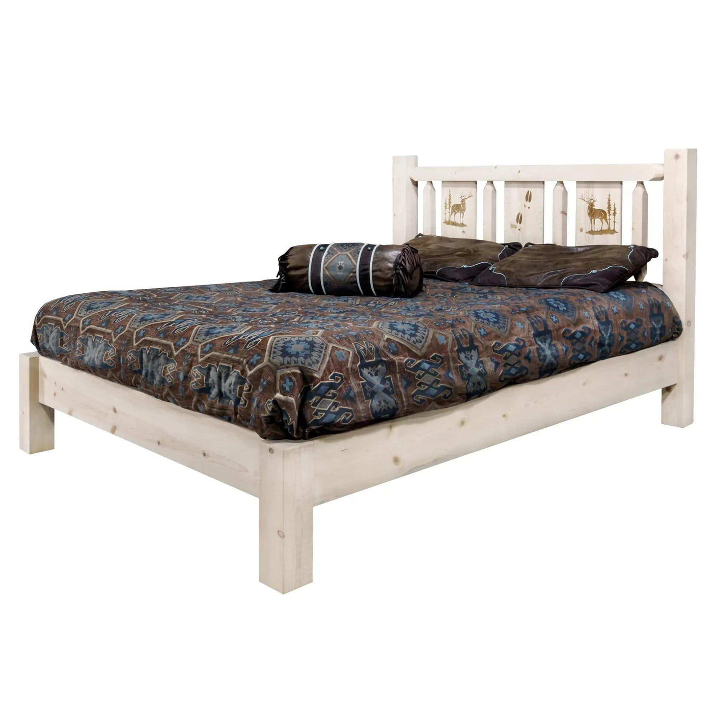 Queen platform bed with light wood frame, engraved wildlife headboard, patterned bedding.
