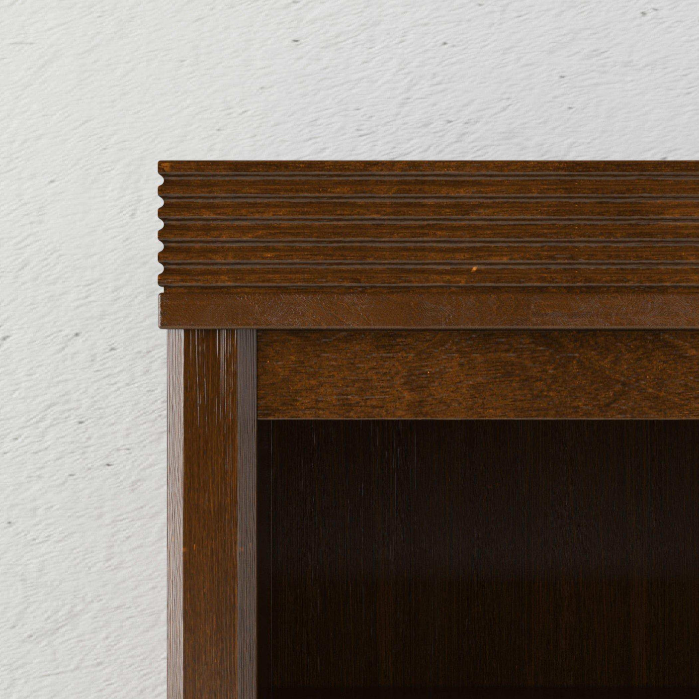 Walnut wood bedroom tower with grooved detail against a light textured wall