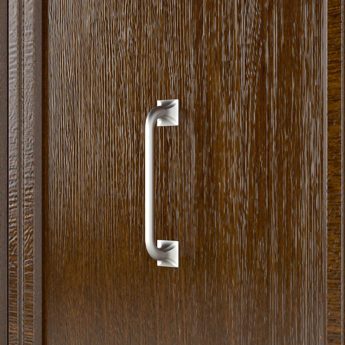 Close-up of brushed metal handle on vertical walnut wood Murphy bed