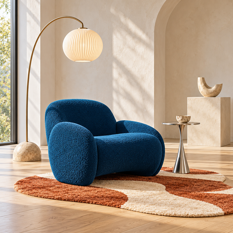 Sculptural blue accent chair with modern lighting, side table and abstract area rug