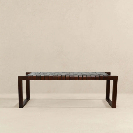 Modern wooden bench with woven leather seat on beige background