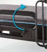 Foldable hospital style bed rail on a gray mattress with blue trim and rotation arrow