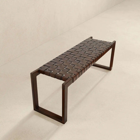 Modern wooden bench with woven leather seat on a light textured floor