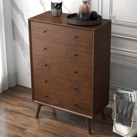 Mid-century modern wooden dresser with decor tray and owl figurine in stylish bedroom