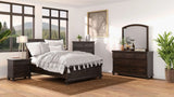 Spacious bedroom with dark wood furniture, large windows, and modern decor accents.