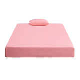 Pink memory foam mattress with matching pillow on white background