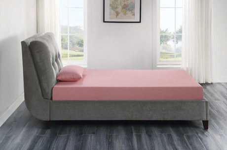 Modern bedroom with a pink mattress and pillow on a gray upholstered bed frame, large windows
