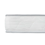 Close-up of white mattress side panel with diamond stitching and gray striped trim