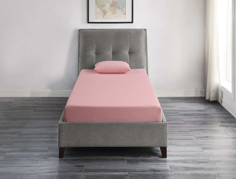 Pink twin mattress with pillow on grey upholstered bed in modern bedroom