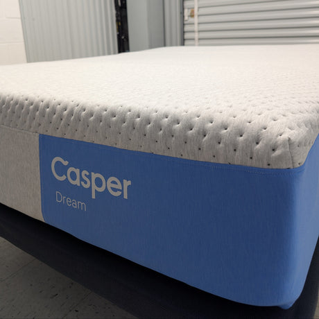Casper mattress with blue and gray design on a bed frame.