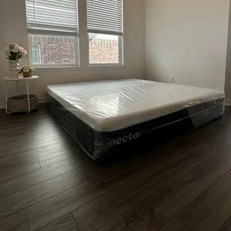 Nectar mattress on a wooden floor with large windows in the background