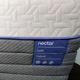 Nectar Luxe Hybrid mattress with a close-up of the brand label.