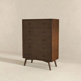 Mid-century modern dark wood dresser with five drawers on angled legs against beige wall