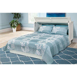 White queen cabinet bed with blue floral bedding in a bright modern bedroom