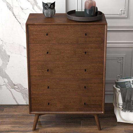 Mid-century modern wooden dresser with four drawers staged in a stylish room