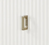Brushed nickel rectangular cabinet pull on white vertical paneled door