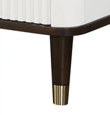 Modern dresser corner with fluted white panel, dark wood leg, and gold metal accent