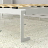 White horizontal Murphy bed frame with metal leg and wood slats on a tile floor