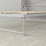 White vertical Murphy bed frame with wooden slats in a modern minimalist room