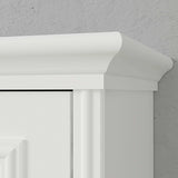 Close-up of white vertical Murphy bed cabinet with crown molding against gray wall