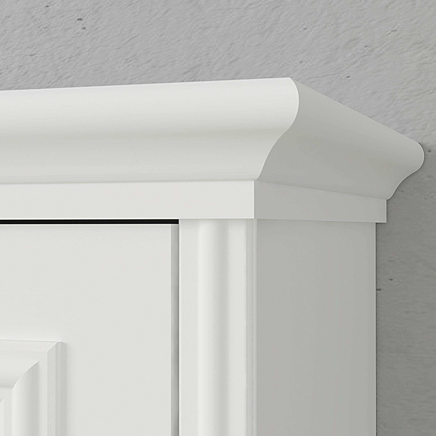 Closeup of white Murphy bed cabinet top with decorative molding against gray wall